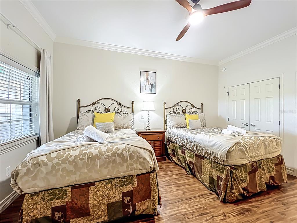 7660 Whisper Way, Unit 402 Reunion, FL 34747 - Photo 26 of 65 a bedroom with a bed and window