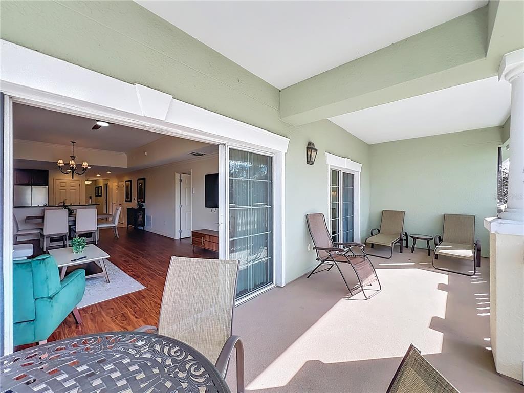 7660 Whisper Way, Unit 402 Reunion, FL 34747 - Photo 42 of 65 a view of a livingroom with furniture window and wooden floor