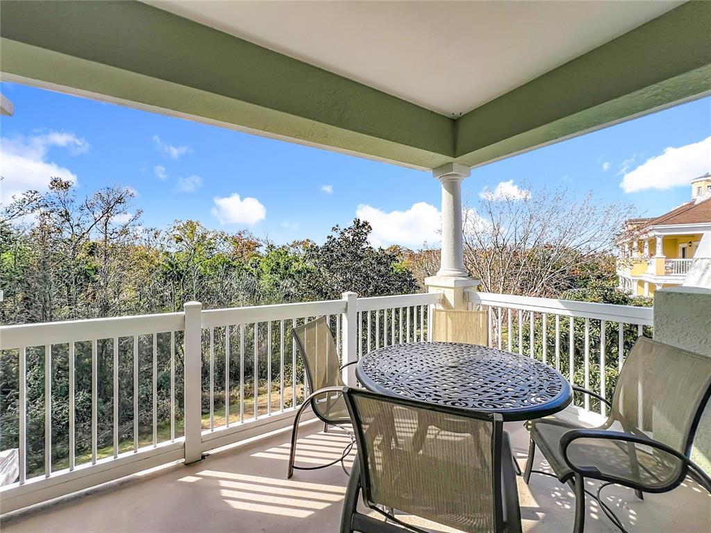 7660 Whisper Way, Unit 402 Reunion, FL 34747 - Photo 43 of 65 a view of a chair and table in the balcony