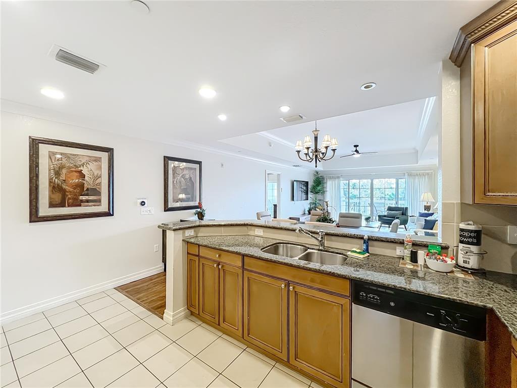 7660 Whisper Way, Unit 402 Reunion, FL 34747 - Photo 9 of 65 a kitchen with stainless steel appliances granite countertop a sink and a stove