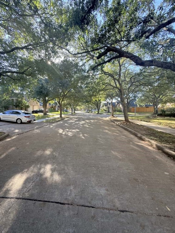 4410 Innsbrook Place Sugar Land, TX 77479 - Photo 15 of 15 a view of a street with a yard and a large tree