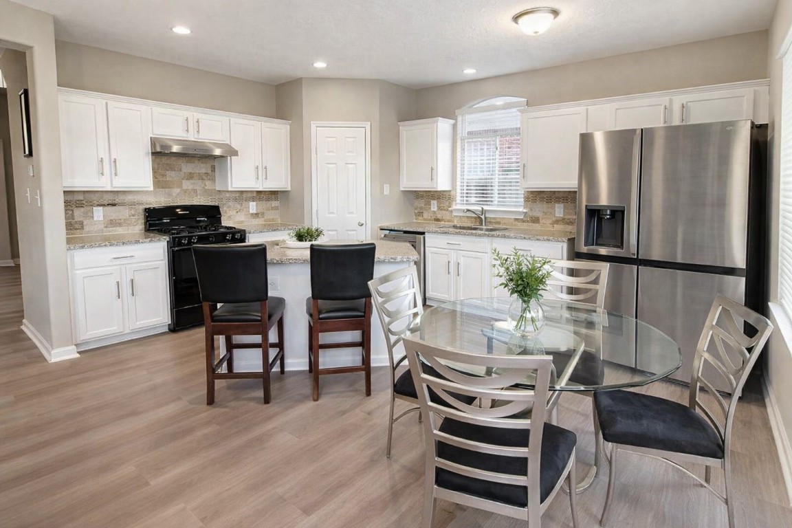4410 Innsbrook Place Sugar Land, TX 77479 - Photo 8 of 15 a kitchen with stainless steel appliances kitchen island granite countertop a refrigerator and a stove top oven