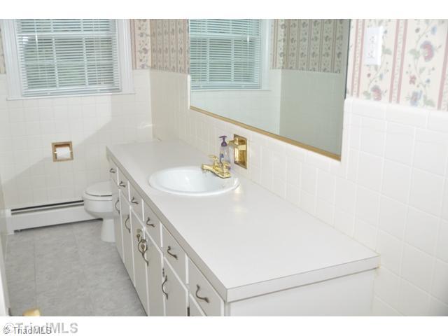 421 Kyle Road Winston-Salem, NC 27104 - Photo 13 of 16 Bath. The welcoming guest bath is crisp and fresh with bright white tiled walls
