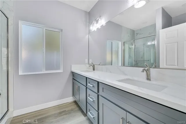 a bathroom with a double vanity sink and a mirror