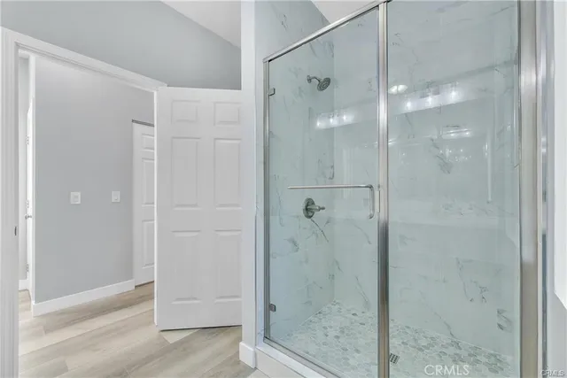 a bathroom with a glass shower door