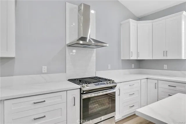 a kitchen with white cabinets and appliances