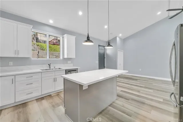 a kitchen with a stove a sink and a window