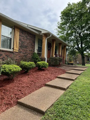 a front view of a house with garden