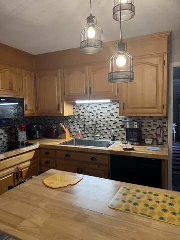 a kitchen with stainless steel appliances kitchen island granite countertop a sink and cabinets