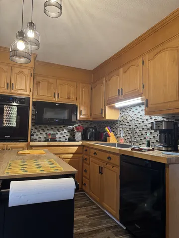 a kitchen with a sink a stove and cabinets