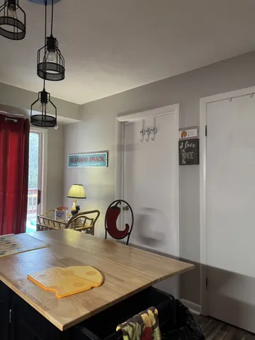 a view of a workspace with furniture and a chandelier