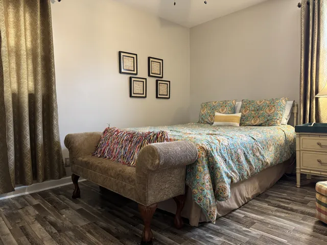 a bedroom with a bed and a mirror