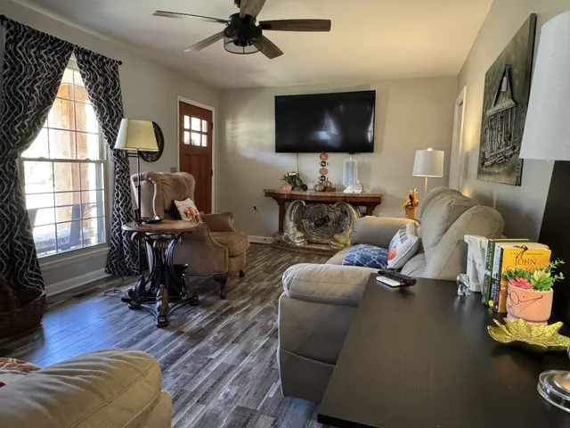 a living room with furniture and a flat screen tv