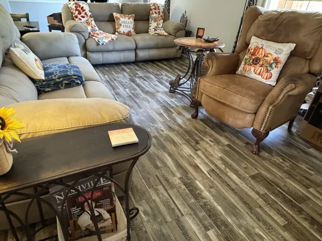 a living room with furniture and wooden floor