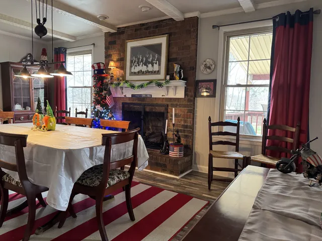 a view of a dining room with furniture and chandelier