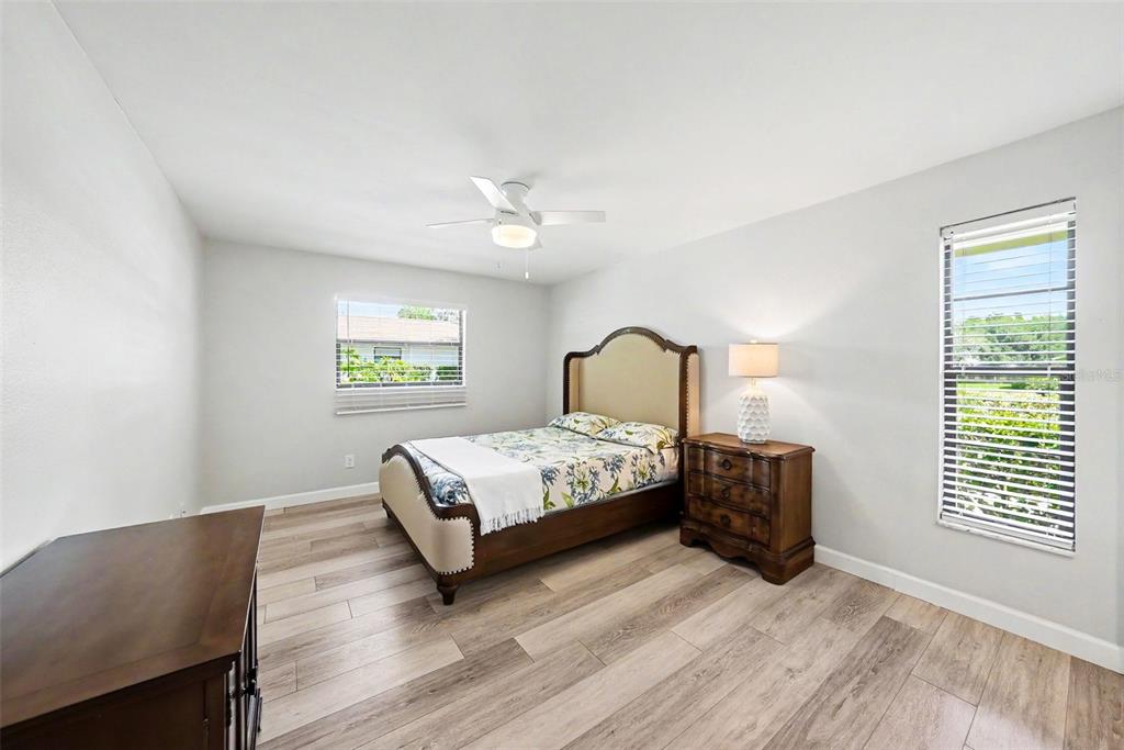 9204 Golf View Drive New Port Richey, FL 34655 - Photo 21 of 33 a bedroom with a bed and a night stand