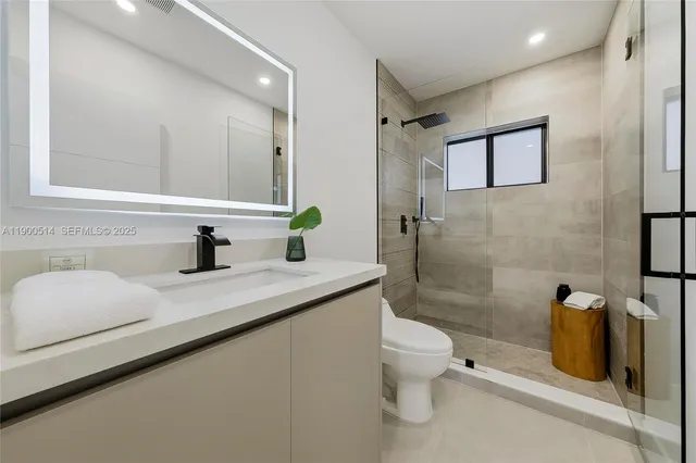 a bathroom with a toilet sink and mirror