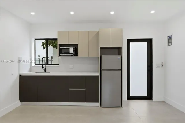 a picture of a bathroom with a white wall