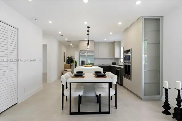 a kitchen with a table and chairs in it