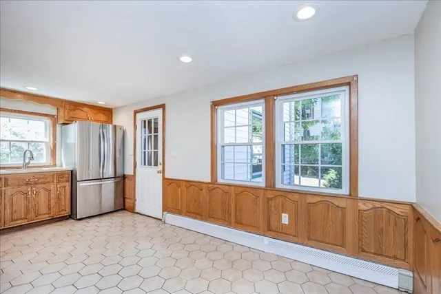 a view of an empty room with a kitchen