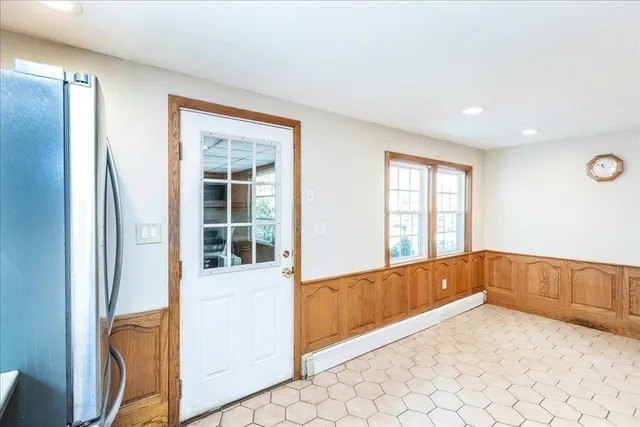 a view of an entryway with wooden floor and windows