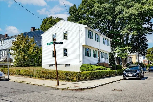 a car parked in front of white house