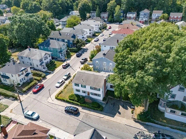 an aerial view of multiple houses with yard