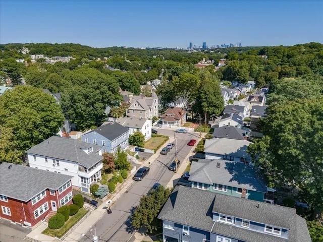 an aerial view of residential houses with outdoor space and street view