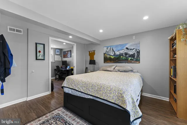 a bed sitting in a spacious bedroom next to a window