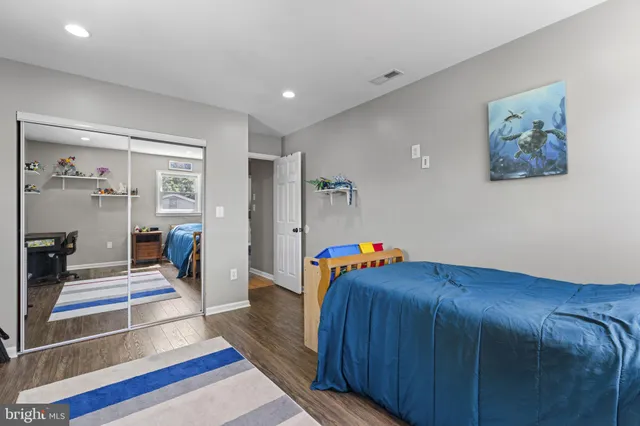 a bed room with a bed and a view of living room