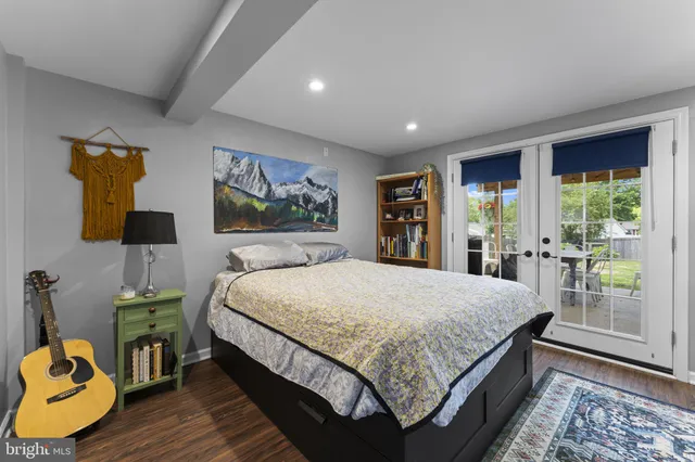 a bed sitting in a spacious bedroom next to a window