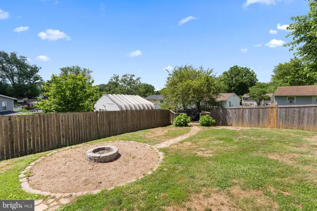 a view of a backyard with wooden fence