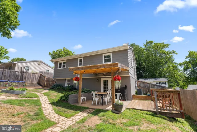 a view of a house with backyard sitting area and garden