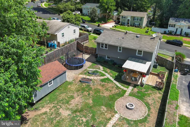 an aerial view of a house with yard and patio