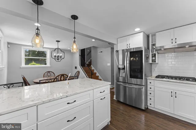 a kitchen with refrigerator cabinets and wooden floor