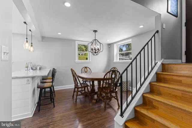 a view of a dining room with furniture wooden floor and chandelier