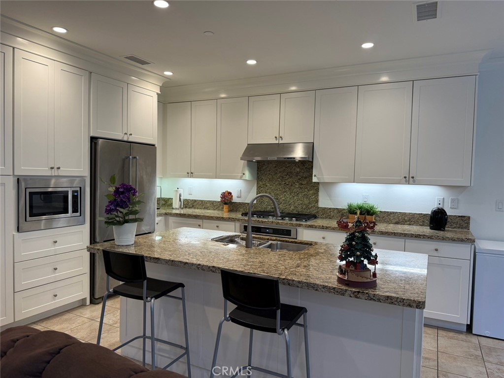 146 Working Irvine, CA 92602 - Photo 5 of 17 a kitchen with a sink a stove and chairs