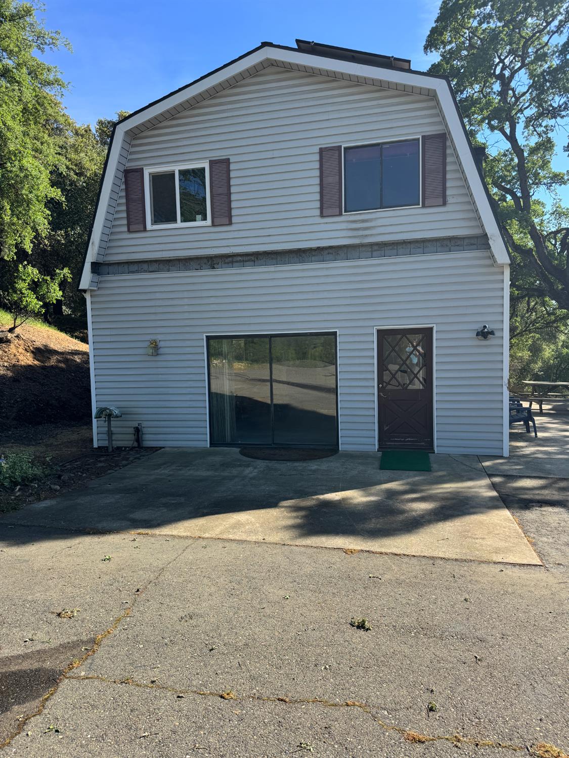 670 Stone House Road Auburn, CA 95603 - Photo 2 of 46 a front view of a house with a yard and garage