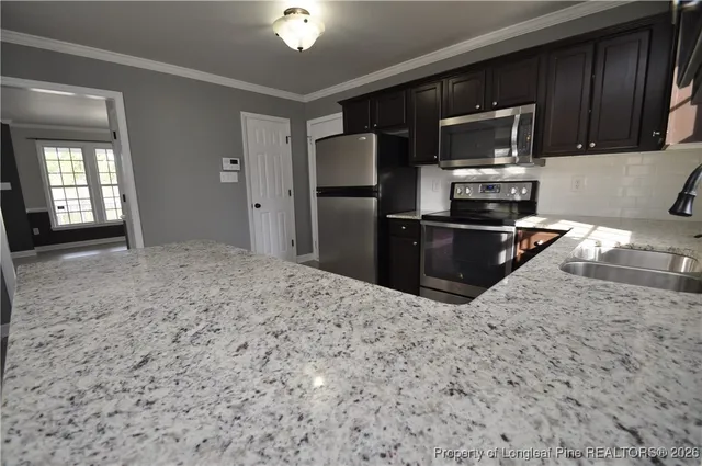 a stove top oven sitting inside of a kitchen