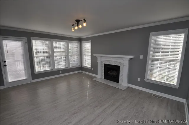 a view of an empty room with a kitchen