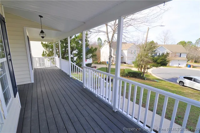 a view of a porch with wooden floor and outdoor space
