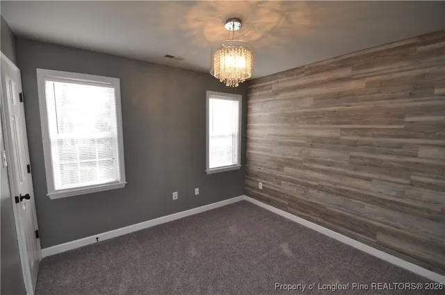 a view of a chandelier and window in an empty room