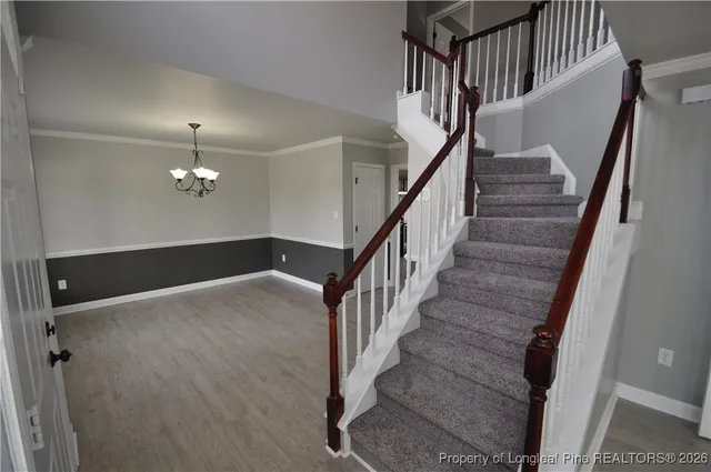 a view of a room with wooden floor and large windows