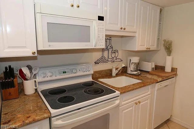 a kitchen with a stove and a white cabinets