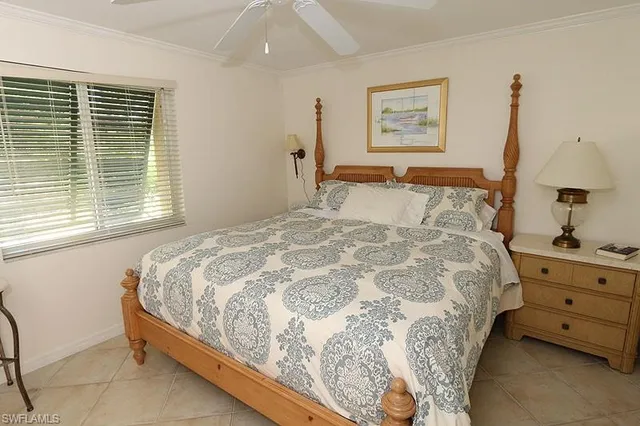 a large bed sitting in a bedroom next to a window