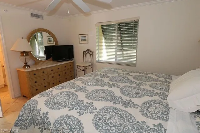 a bedroom with a bed and a television