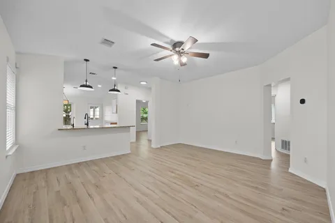 a view of a kitchen with wooden floor and a sink