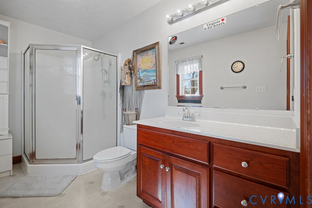 7601 Amelia Springs Road Jetersville, VA 23083 - Photo 8 of 21 a bathroom with a sink a toilet and shower