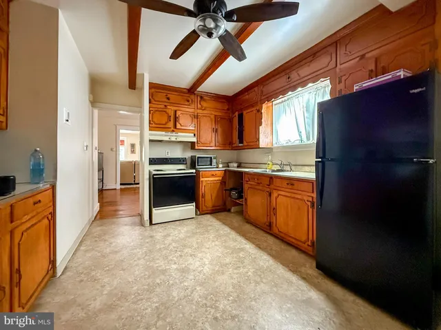 a kitchen with stainless steel appliances granite countertop a stove refrigerator sink and cabinets