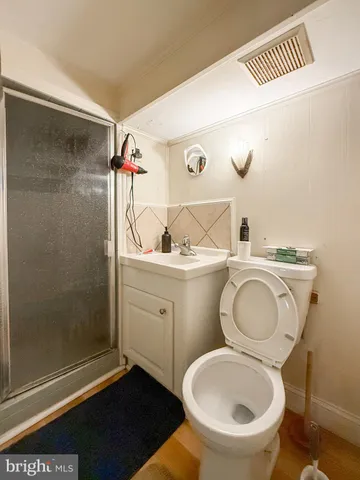 a bathroom with a toilet sink and shower